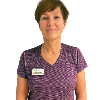 An image of Debbie Mcleod in a striped purple shirt, wearing a name tag from Horder Healthcare