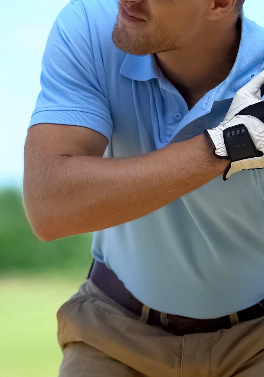 Young male golf player suffering terrible shoulder spasm after shot, trauma