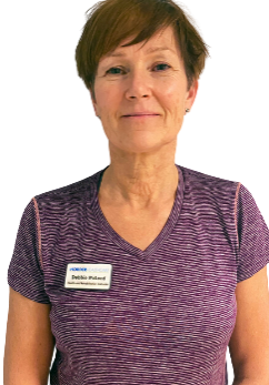 An image of Debbie Mcleod in a striped purple shirt, wearing a name tag from Horder Healthcare